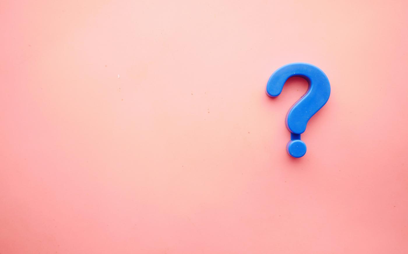 a blue question mark on a pink background by Towfiqu barbhuiya courtesy of Unsplash.