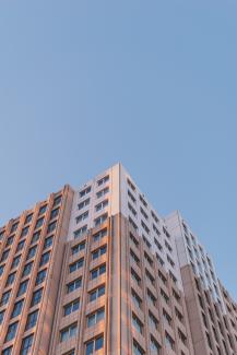 brown concrete building under blue sky by Niels Smeets courtesy of Unsplash.