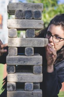 woman playing with wooden blocks by John Moeses Bauan courtesy of Unsplash.