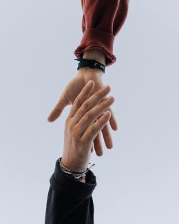 view of two persons hands by Austin Kehmeier courtesy of Unsplash.