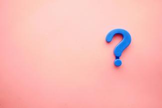 a blue question mark on a pink background by Towfiqu barbhuiya courtesy of Unsplash.