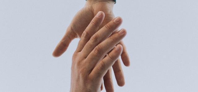 view of two persons hands by Austin Kehmeier courtesy of Unsplash.
